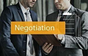 "how to negotiate in business image with people negotiating"