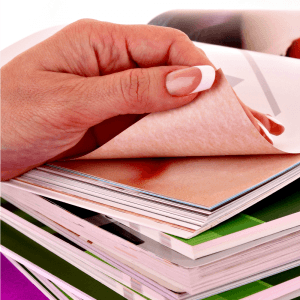 "female hand thumbing through printed products"