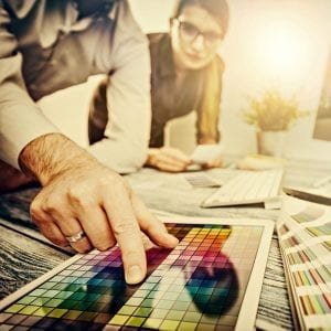 "two web designers working on a color block"